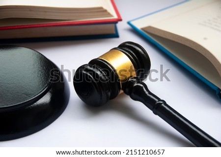 Lawyer gavel on white cover with books background. Law concept