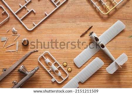 Scale model of the airplane fighter with details. Plastic assembly kit. Top view. Copy space Royalty-Free Stock Photo #2151211509