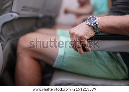 Scared man strongly grab armrest in plane Royalty-Free Stock Photo #2151213599