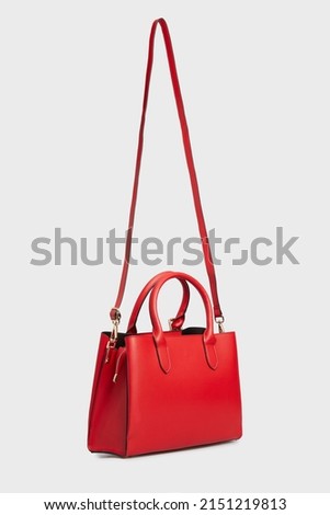 Side View on Women's Red Leather Bag Handbag Handing Isolated on White Background. Women Top Handle bag with gold buckle Royalty-Free Stock Photo #2151219813