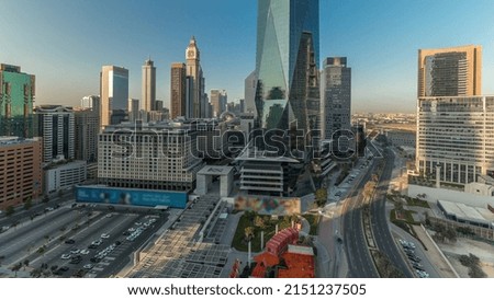 Panorama showing Dubai International Financial district aerial timelapse. View of business and financial office towers. Skyscrapers with hotels and shopping malls near downtown