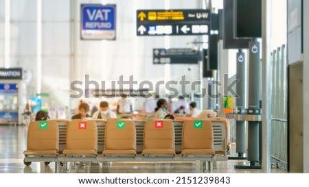 View of sign mark on seats in airport terminal for social distancing campaign during outbreak of Covid 19