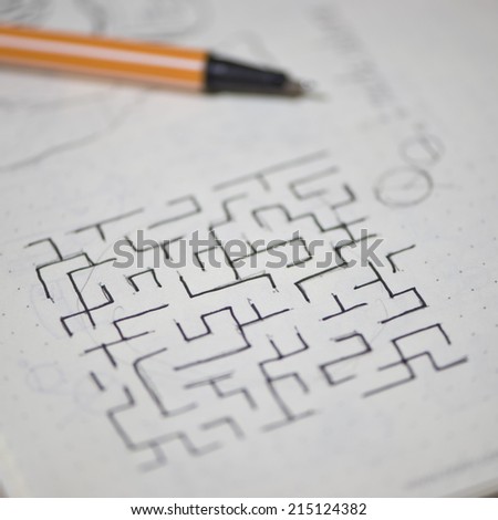 sketch of maze in notebook , selective focus.