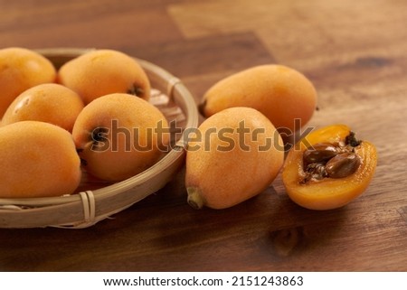 Loquat fruit on a wooden background