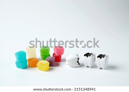 A lot of colorful cubes sweet jelly sugar with Decayed cavity tooth                               