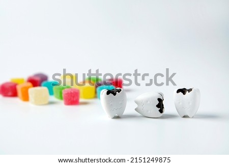 Should eat sugar in moderation to prevent tooth decay and lost teeth, decay tooth with sweet sugar jelly on white background                               