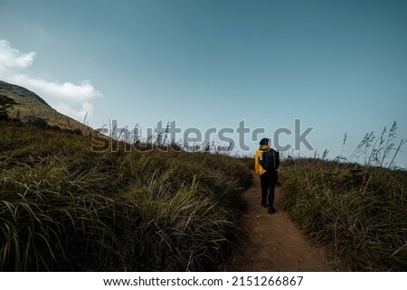 Young man hiking at Chembra Peak Kerala, travel photographer with backpack 