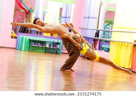 Ukrainian gymnast doing gymnastics with aerial hoop or aerial hoop in the fitness room. 