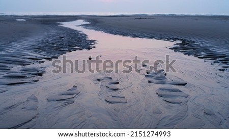 A Stream of water on the beach on the French opal coast pastel colors Copy space Horizon structure