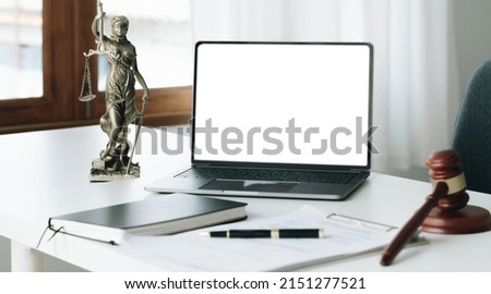 Workspace of lawyer with laptop blank white screen and law wooden gavel,legal book and brass scale of judge. lawyer and law ,judiciary and legislature courtroom legal concept.

