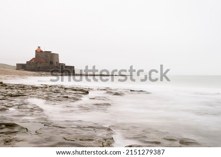 The 18th century Fort Vauban, in Ambleteuse near Boulogne on the Opal Coast in France in a milky white and grey sea