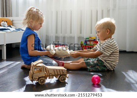 kids are fighting over a toy. conflict between sister and brother. sibling relationships Royalty-Free Stock Photo #2151279453