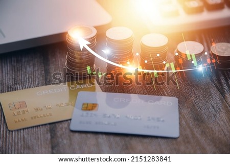 Credit bank card, money and coins on the home wood table, with selective focus, soft light and vintage filter, business concept