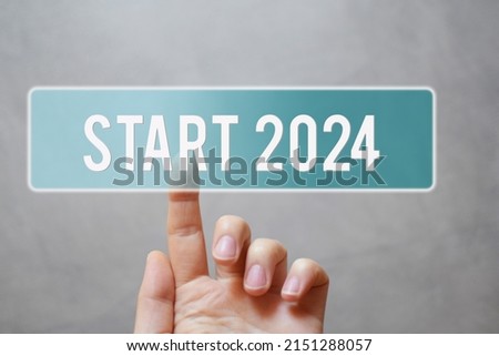 Finger pressing blue transparent start 2024 button on virtual interface on gray background with copy space for text. Concept of new year.
 Royalty-Free Stock Photo #2151288057