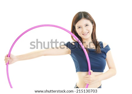 Young woman with hula hoop over white