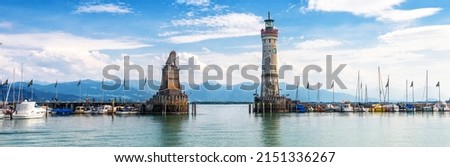 Lake Constance, panoramic view of harbor entrance in Lindau island, Germany, Europe. Landscape with old lighthouse in marina, scenic panorama of Bodensee in summer. Lindau is attraction of Bavaria. Royalty-Free Stock Photo #2151336267