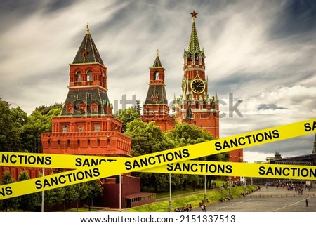 Sanctions caution tape at Moscow, Russia. Warning information on Kremlin background. Concept of restrictions of Russia, world crisis, Russian economy, politics, tension, russophobia and geopolitics. Royalty-Free Stock Photo #2151337513