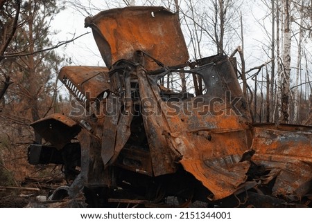 Burnt out military truck after being hit by a shell