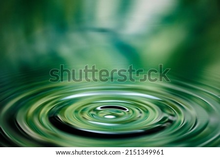 Water droplets and ripples falling on the surface of the water Royalty-Free Stock Photo #2151349961