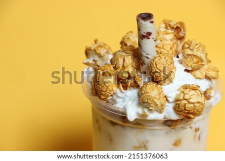 ice cream popcorn in cup  isolated yellow backgroud