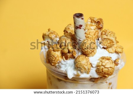ice cream popcorn in cup  isolated yellow backgroud