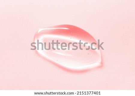 Beauty serum gel drop on pink background. Clear skincare product with bubbles texture macro Royalty-Free Stock Photo #2151377401