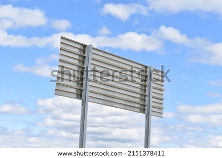 Blank sign under a cloudy blue sky