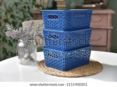 Several blue plastic boxes on the table. Boxes for storing items.