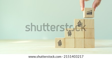 Growth of sales, average order value (AOV) concept. Strategy to get more money per oder. Increase sales in online store, e-commerce. Stacking wooden cubes with sales growth on grey background. Royalty-Free Stock Photo #2151403217