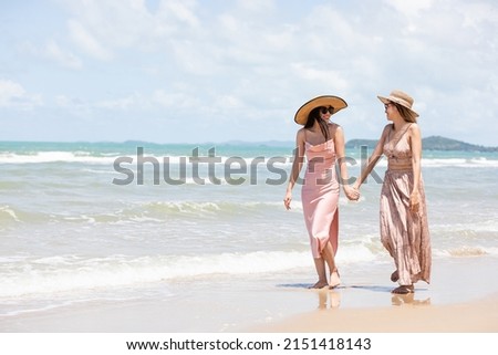 romantic young lesbian couples in love and walking together on the beach Royalty-Free Stock Photo #2151418143