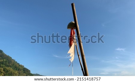 Broken Indonesian flag with blue sky background and hills