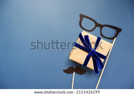 Happy Father's day decoration background top view. Flat lay out a gift box and Daddy props on blue background. for Father's day design. 