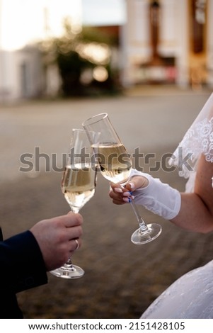 Brides drink champagne from clear glasses