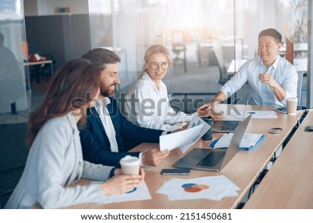 Confident and successful team. Group of people are working together in office. Blurred background