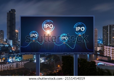 IPO icon hologram on road billboard over night panorama city view of Bangkok. The hub of initial public offering in Southeast Asia. The concept of exceeding business opportunities.