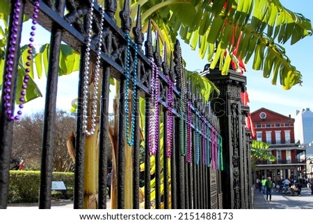 Mardi Gras beads hanging on a fence in Jackson Square in New Orleans