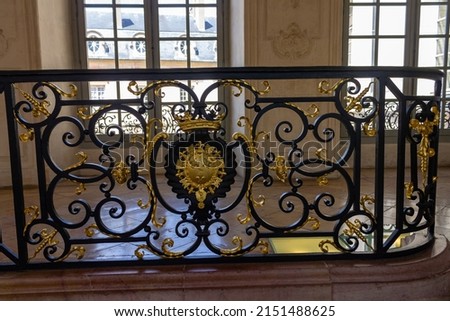 The Detail of the gilded adornments inside a historical building during daytime in Dijon, France Royalty-Free Stock Photo #2151488625