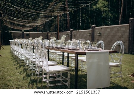 rectangular wedding festive set table in the patio, garden in nature