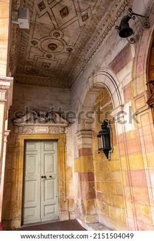 A vertical shot of the hall with adorned walls and a door  Dijon, France  Royalty-Free Stock Photo #2151504049