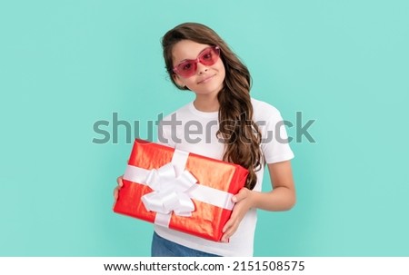 fashionable happy kid in sunglasses hold gift box, birthday