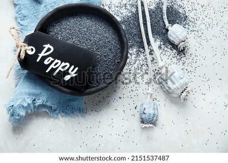 Composition with poppy seeds on gray background. Organic food concept. Top view, flat lay, copy space