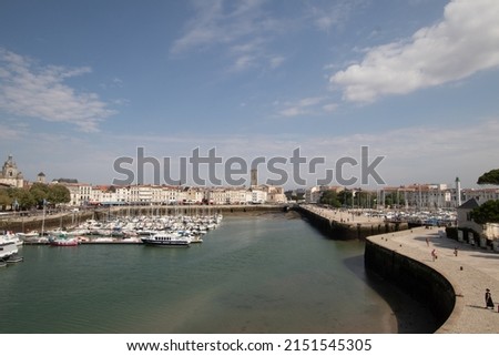 A view of harbour with floating boats in background of La Rochelle tower
