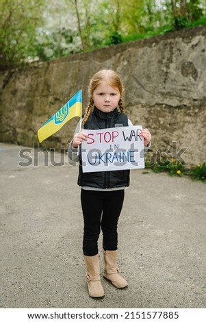 Portrait little child calls no war, raises banner with inscription Stop war in Ukraine and blue-yellow flag of Ukraine. Peace, stop russian aggression. United Europe against Russia. Hope for world
