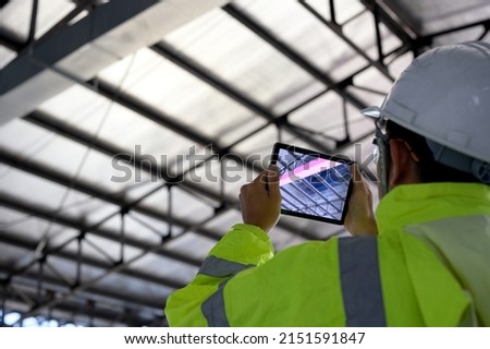 Construction Civil Engineer use technology software through tablets to scan building construction and inspection to show augmented reality in work, Building information model or BIM concept Royalty-Free Stock Photo #2151591847
