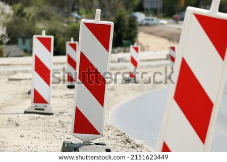 Warning bollards at the construction of a new road in the city.