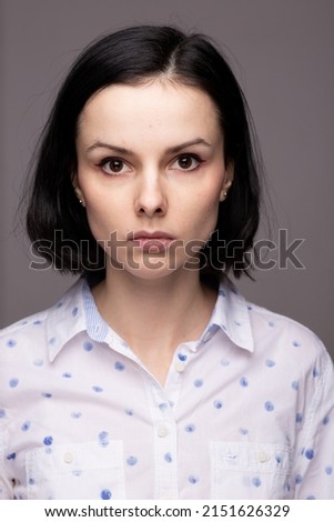 brunette woman in white polka dot shirt. High quality photo