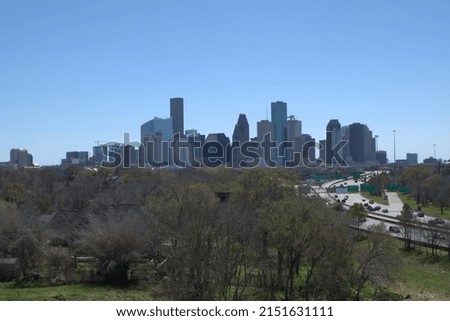 A panoramic view of Houston city skyline under blue sky