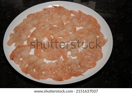 Cleaned pink shrimp on white plate