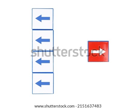 Outstanding right red arrow among left ones isolated on white background. Thinking differently, extraordinary, individuality, standing out from crowd, uniqueness concept. High quality photo