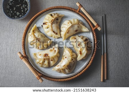 Gyoza Japanese korean dumplings on gray plate on the tabl. Top viewe Royalty-Free Stock Photo #2151638243